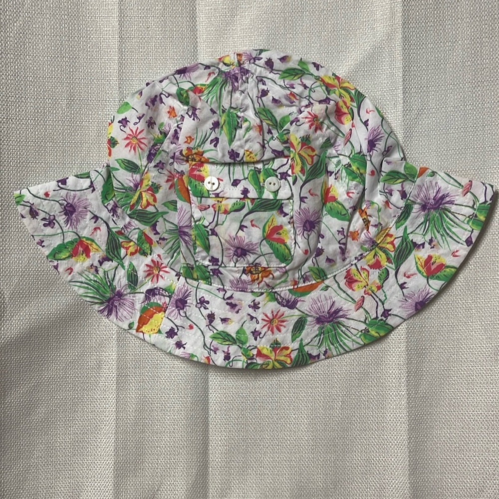 A bucket hat with pink and purple flowers, green stems. Perfect for baby girls.
